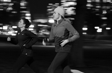 Two women running at night.