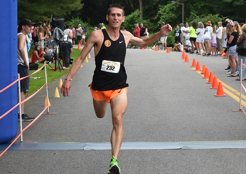 Coach Chris at finish line of 2021 Bobby Doyle 5-Miler