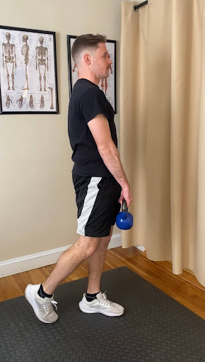 Alex Burke, PT demonstrating how to perform a kickstand RDL exercise to lengthen and strengthen hamstrings.
