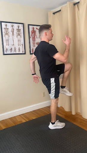 Alex Burke, PT demonstrating how to perform a reverse lunge to strengthen glute muscles.